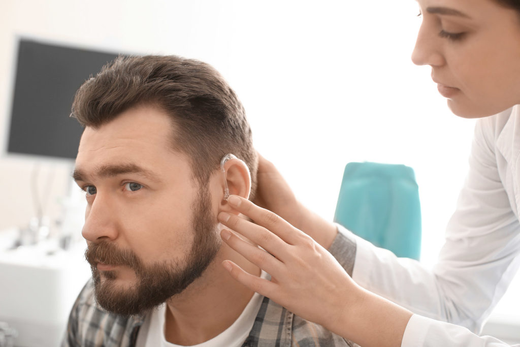 Man having hearing examined at doctor.